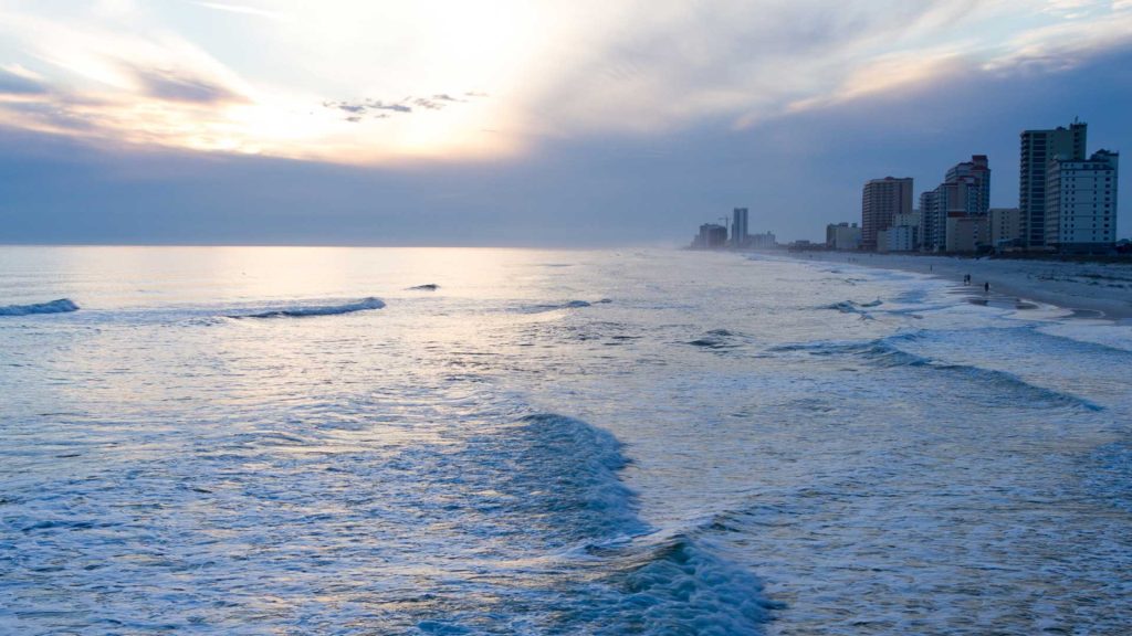 a body of water with buildings in the background